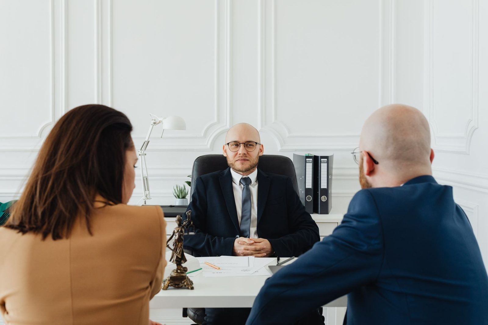 Clients meeting a lawyer across a desk