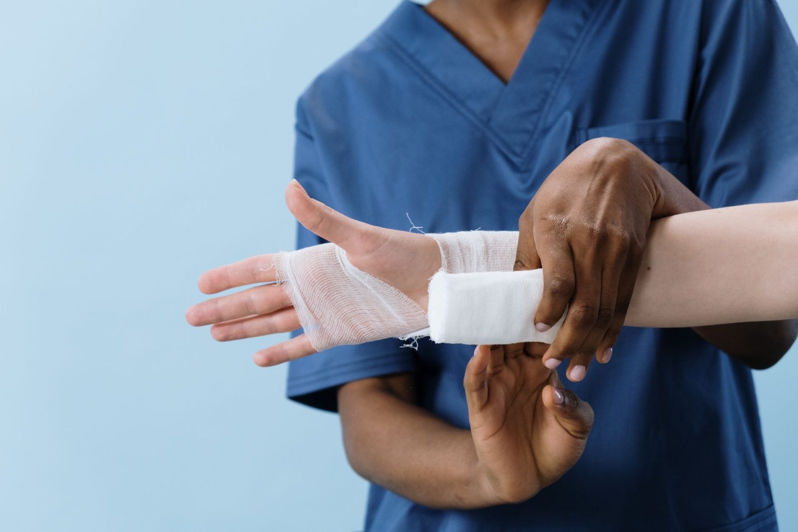 Bandaged wrist being treated