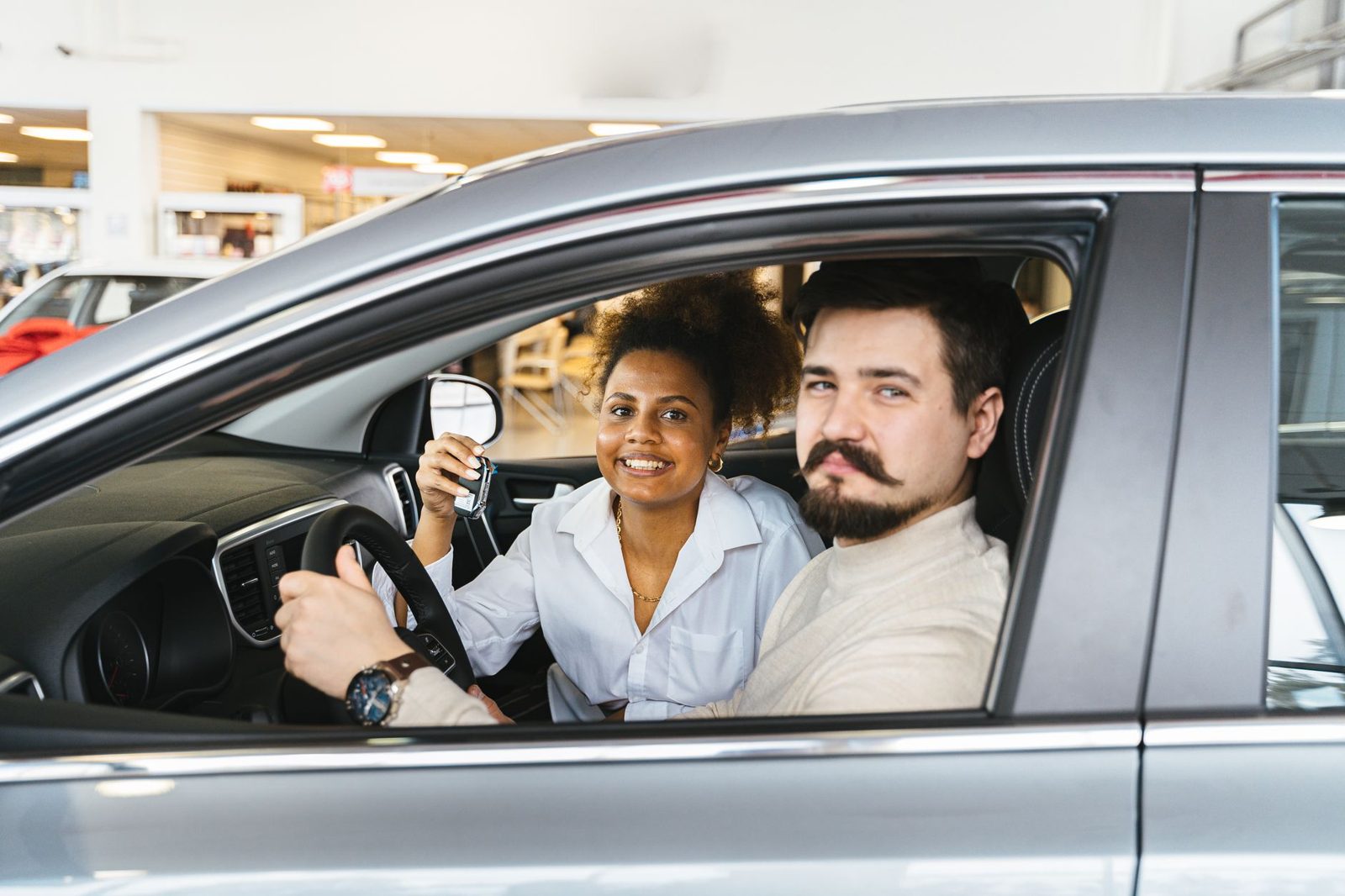 Couple sitting in a car holding the keys